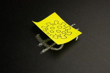 Dollar sign on a blackboard closed with a coronavirus sticker. Concept of an epidemic and pandemic. Danger and fall of the economy.