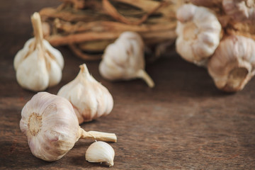 Garlic cloves and garlic on an old wooden table
