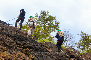 Men and women rock climbing