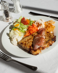 welsh rarebit served on a plate with bacon and salad