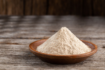 Banana powder in bowl on the table, close-up