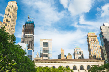Fototapeta na wymiar New York City skyline and beautiful cloudy sky background. Low angle view, perspective, copy space