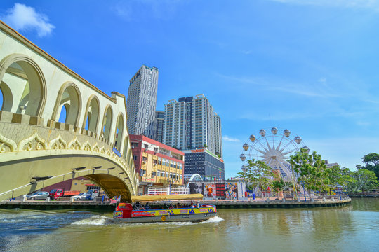 MALACCA, MALAYSIA - JAN 31, 2016 : Cruise tour boat sails on the Malacca River in Malacca. Rehabilitation of the Malacca River to develop river tourism started in July 2002