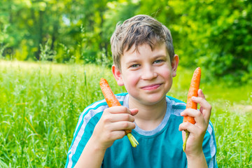 teen boy with a carrot in a forest