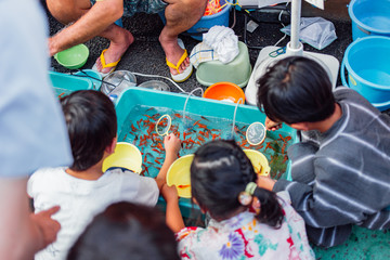 Kids playing game at Japanese summer festival