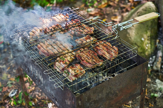Picture of meat cooked on charcoal.