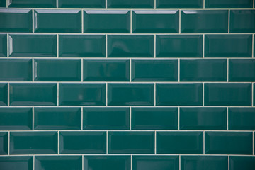 Emerald bricks. Brick type tile with white seams. Bricks are laid out in even repeating rows. The tile test has a glass base.