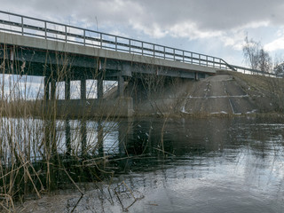 Fototapeta na wymiar concrete bridge over the river, spring day