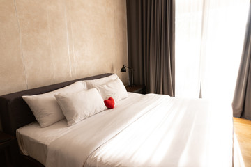 Loft Style Bedroom Interior Design with Red heart and white pillow on the bed for love, wedding and valentine's day concept