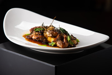 delicious succulent quail grilled with a side dish, nice presentation