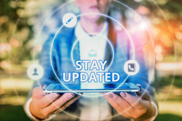 Conceptual hand writing showing Stay Updated. Concept meaning keep modern recent or containing the...