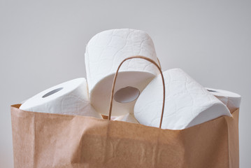 Toiket paper rolls in shopping bag. Buying panic about coronavirus covid-19 for home quarantine concept