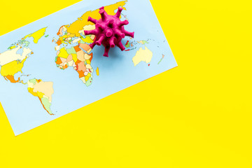 Corona virus Covid-19 - epidemic concept with world map - on yellow background top-down copy space