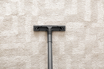 Hoovering of carpet with vacuum cleaner, top view