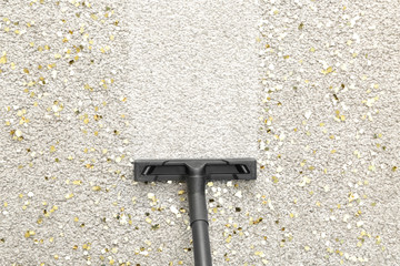 Hoovering of carpet with vacuum cleaner, top view