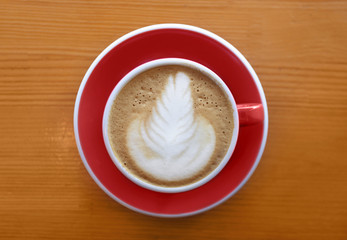 Cup of tasty cappuccino on wooden table