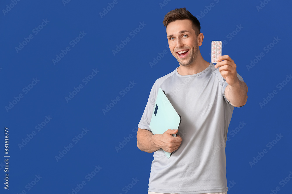 Sticker Young man with weight loss pills and scales on color background