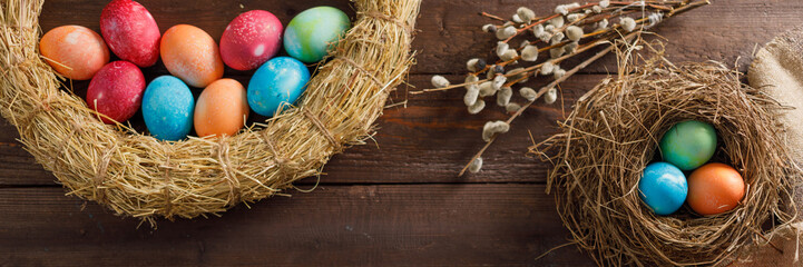 Still life of easter eggs in a bird's nest on a wooden background. Rustic. Easter celebration concept. Copy space. Flat lay.