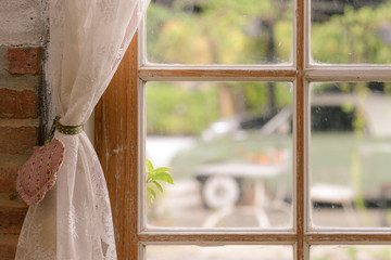 Close up of transparent white lace tulle on the window. Curtain and window interior decoration in vintage style