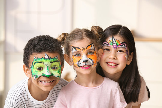 Funny little children with face painting at home