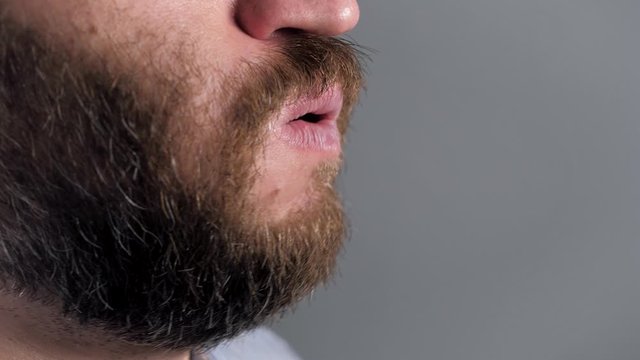 Man coughs and covers her mouth with napkin. Colds, flu, laryngitis, tuberculosis, asthma, bronchitis, allergies, pneumonia, APF inhibitors, nasopharyngeal leakage concepts. Side view. Close-up