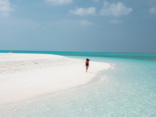 Beautiful Young Woman Run on the Maldivian Beach.