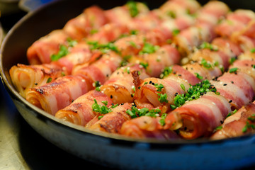 Prawn wrapped with bacon and rosemary. baked appetizer. Close-up shot.