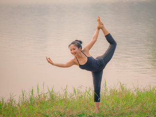 Yoga woman on green grass.