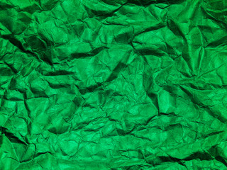 Closeup view of green crumpled paper texture background.