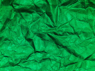 Closeup view of green crumpled paper texture background.