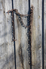 Old rusted chains near the fence