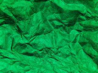 Closeup view of green crumpled paper texture background.