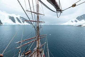 sailing ship in lemaire channel antarctica with snow  and ice 