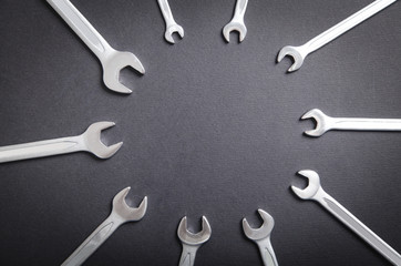 Different sizes wrenches on the black background.