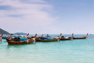 Obraz na płótnie Canvas Traditional long tail boat on white sand beach in Thailand. Travel and Holiday concept, Tropical beach, long tail boats, gulf of Thailand. Long boat and tropical beach, Andaman Sea.