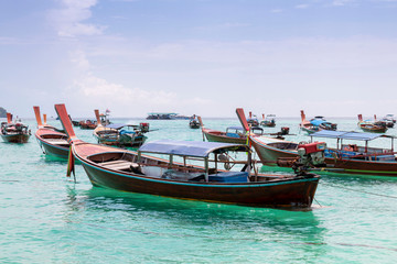 Fototapeta na wymiar Traditional long tail boat on white sand beach in Thailand. Travel and Holiday concept, Tropical beach, long tail boats, gulf of Thailand. Long boat and tropical beach, Andaman Sea.