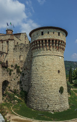 The tower of the old fortress on the top of the hill. Brescia, Italy. Soft focus, blurry background.
