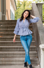 Young Asian Girl walking down stairs in Europe city. Europe city woman traveller lifestyle. Travel Europe summer holiday girl enjoying her holiday. Vacation and Holidays in Zurich and Europe concept.