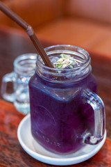Butterfly pea flower drink with lime , honey and mint leaf , fresh herbal healthy detox drink. Purple lemonade drink in summer.