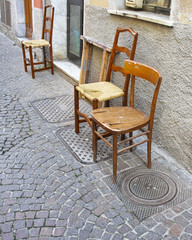 Fototapeta na wymiar detail of old wooden chair in a street