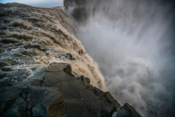 Beautiful Icelandic waterfall at sunset with huge quantity of flowing waters Iceland