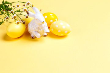 Yellow easter eggs with cute bunny on a yellow background.