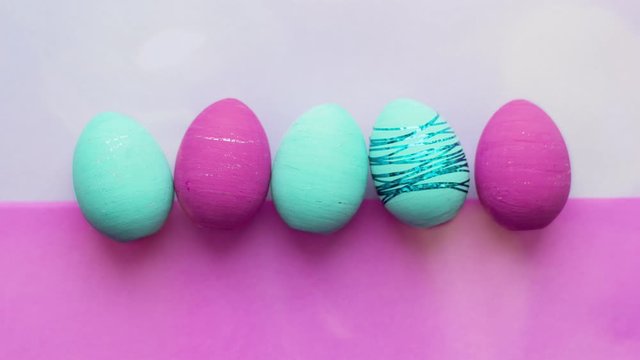 Easter eggs on a colored background under the sun glare.