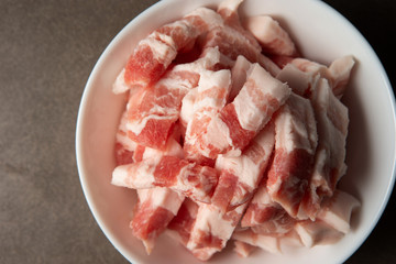 Fresh raw pork in white bowl