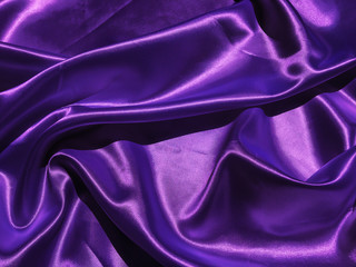 Obraz premium Pattern of purple fabric texture background. wavy folds of grunge silk texture satin velvet material for design
