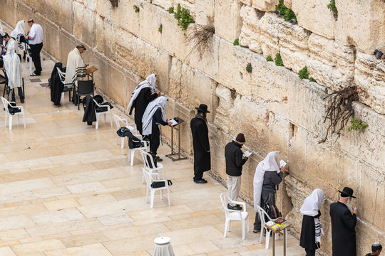 Jewish believers pray near the Kotel in the Old Town of Jerusalem in Israel