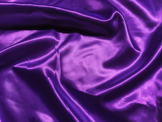 Closeup of purple satin or silk texture background. Copy space  with  elegant wallpaper design