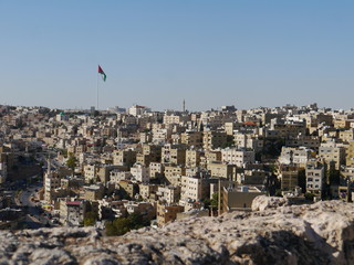 panoramic view on skyline of Amman with Jordanian flag, kingdom Jordan, Middle East