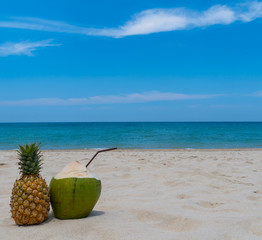 Refreshing pineapple and coconut on a beautiful sandy exotic beach