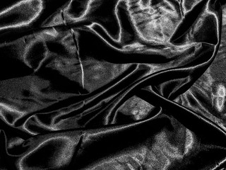 luxury black silk or satin texture background with liquid wave or wavy folds. Wallpaper design